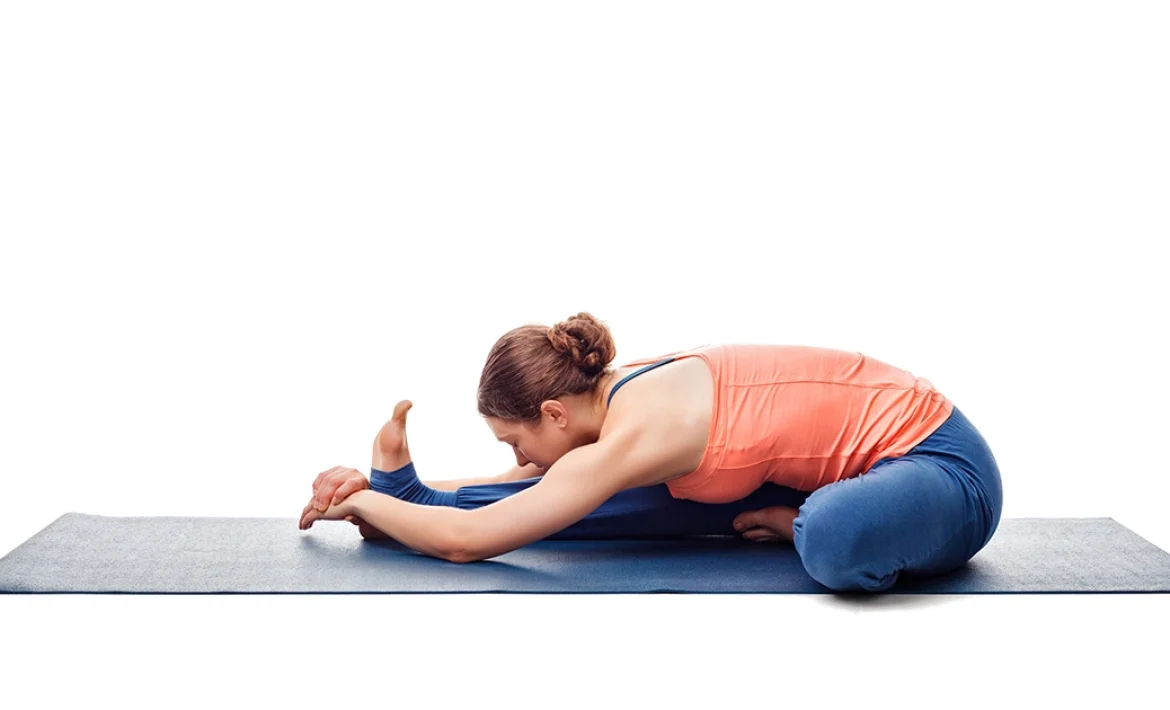 A yoga practitioner demonstrates proper chest rotation and safe knee alignment while holding Janushirsasana.