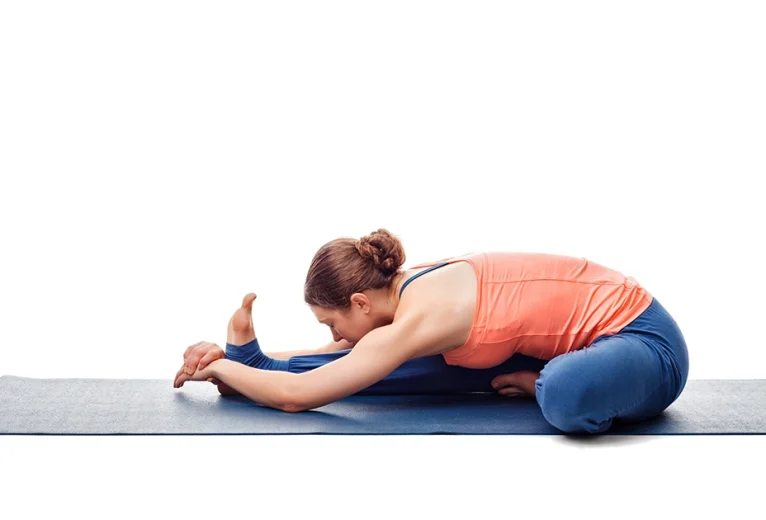 A yoga practitioner demonstrates proper chest rotation and safe knee alignment while holding Janushirsasana.
