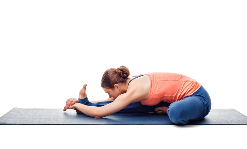 A yoga practitioner demonstrates proper chest rotation and safe knee alignment while holding Janushirsasana.