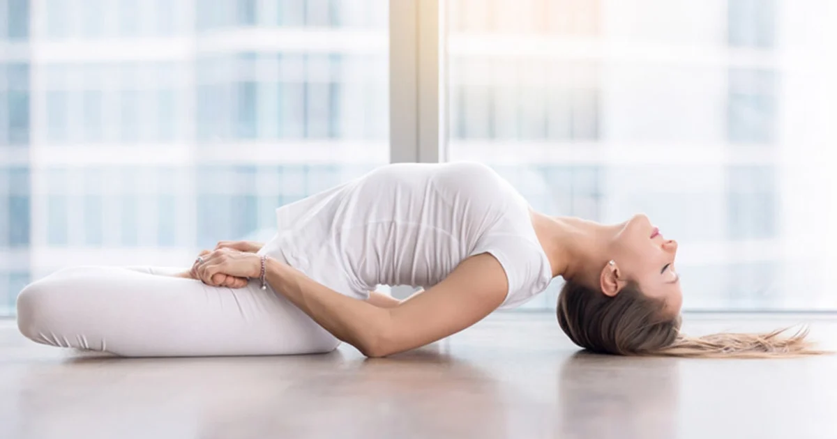 A yoga practitioner demonstrates an open chest and light crown grounding in Matsyasana.