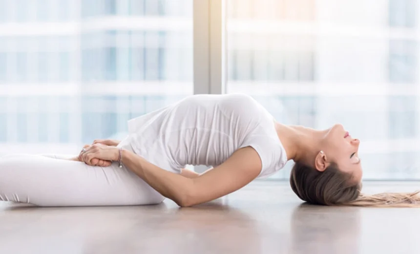 A yoga practitioner demonstrates an open chest and light crown grounding in Matsyasana.